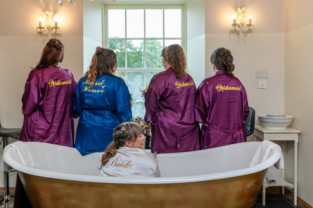 Bride and Bridesmaids around the bridal suite bath at Logie Country House, Aberdeen