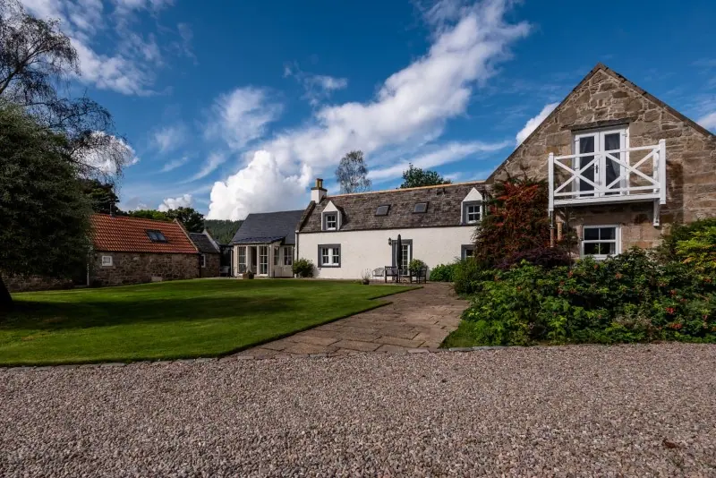 Stone cottage exterior with gravel drive