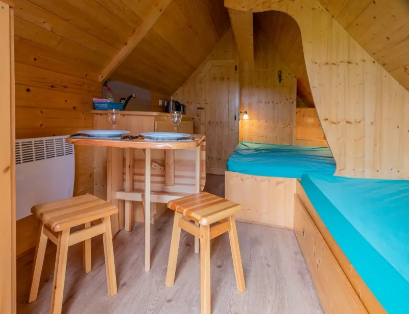 Pine-clad glamping pod interior