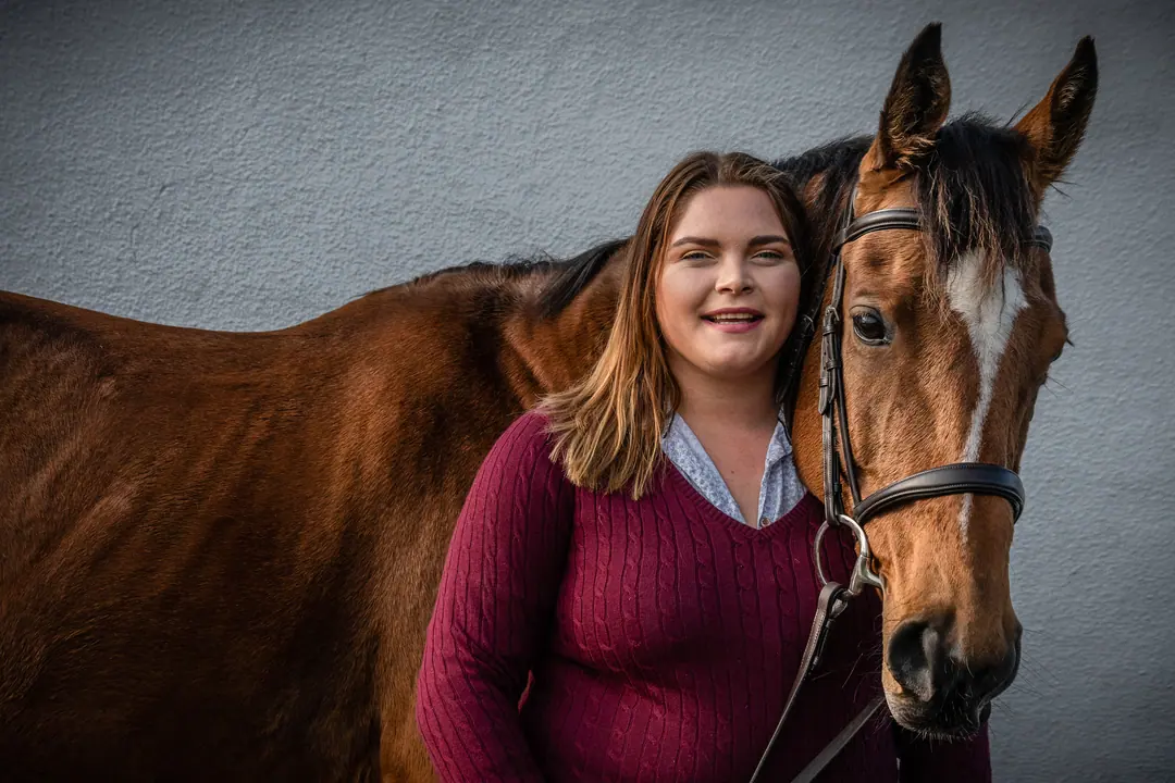 Young woman with her horse