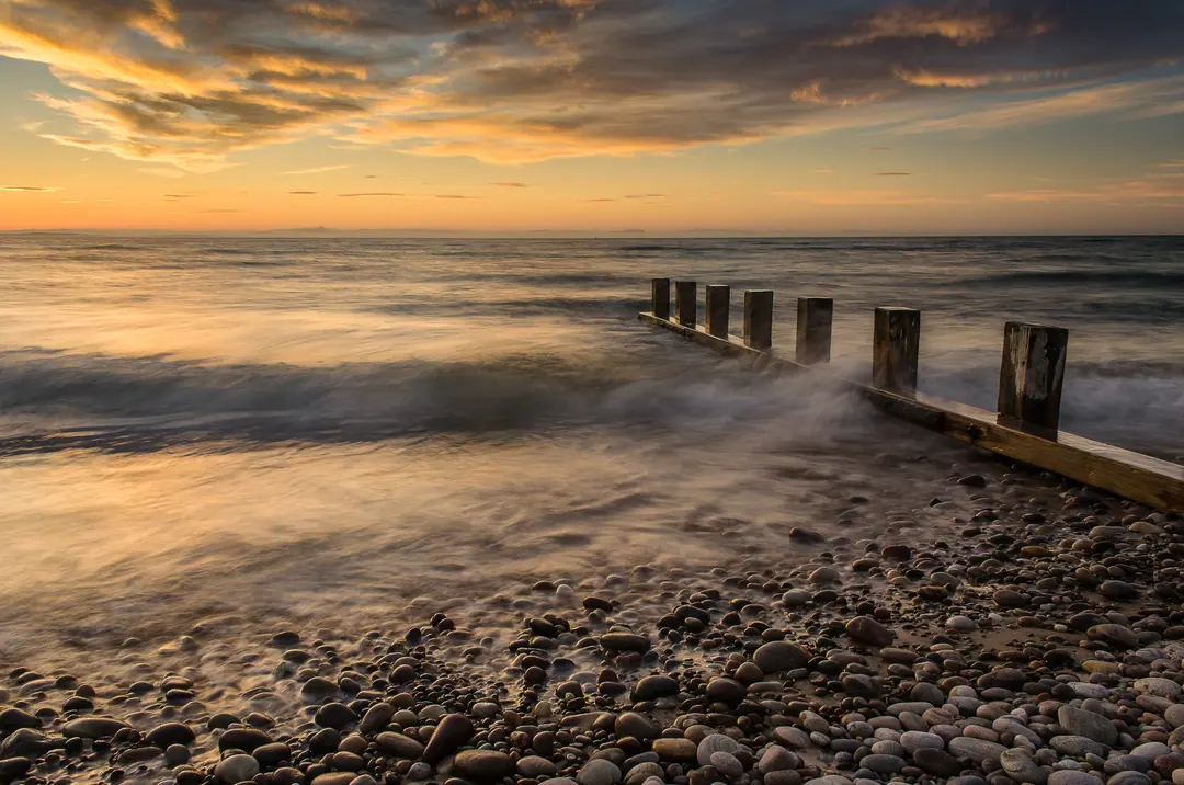 Sunset over timber groynes on the coast