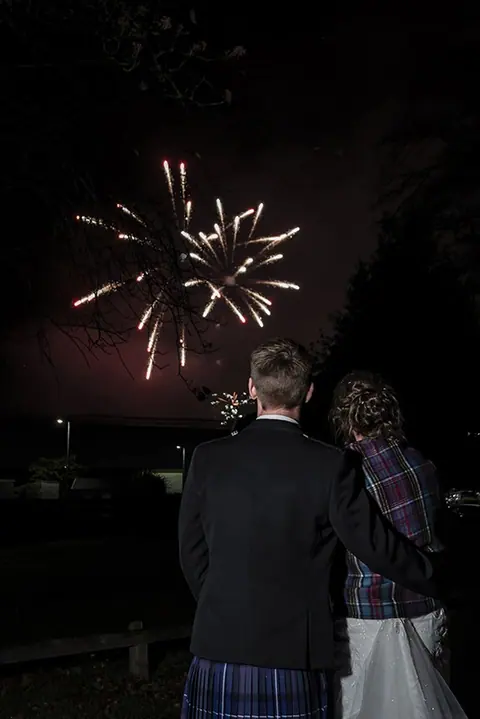 Couple watching fireworks at night