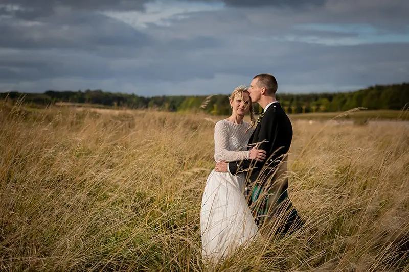 Couple in golden grasses at sunset