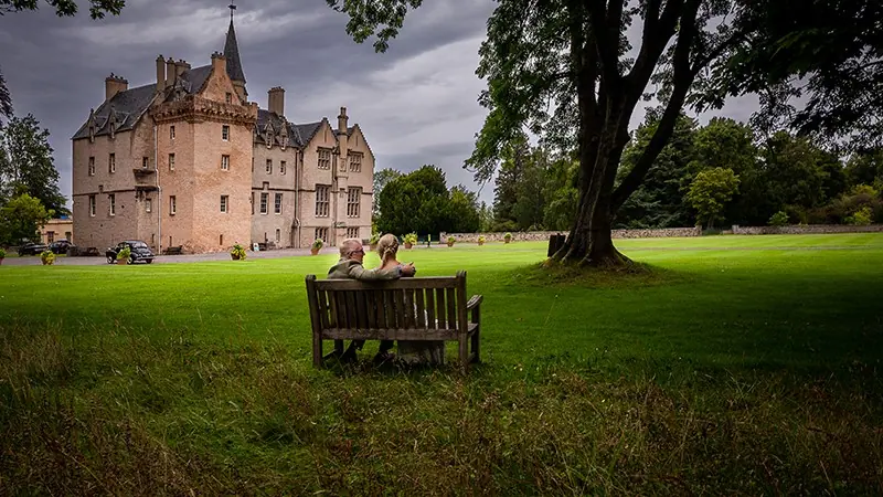 Couple on the lawn of a Scottish castle