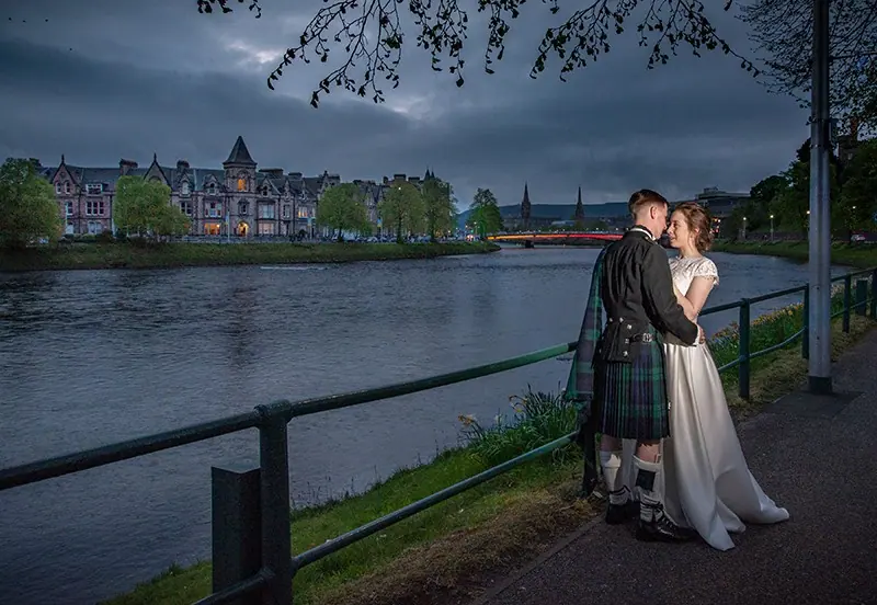 Couple beside the River Ness at dusk, Inverness