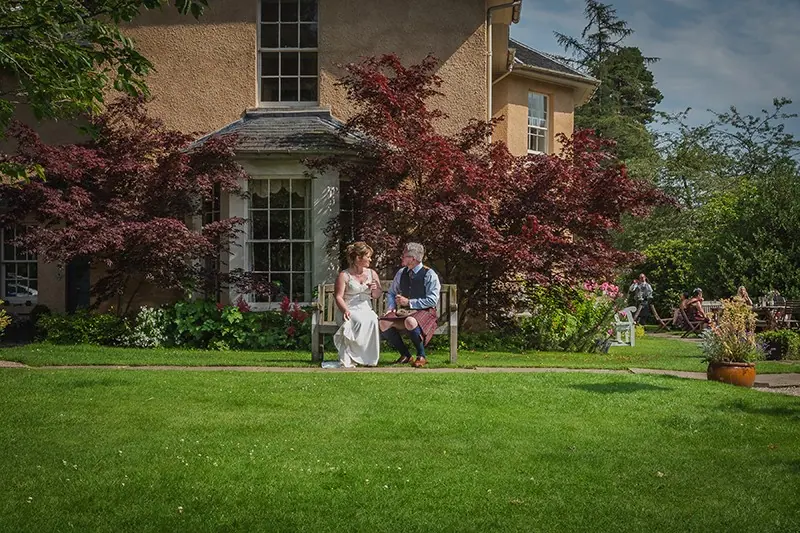 Couple on the lawn of a country house