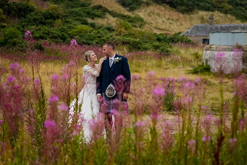 Couple among pink wildflowers